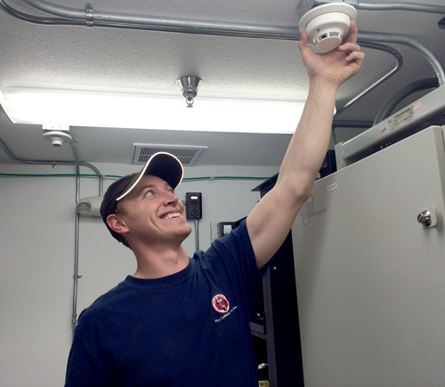 employee-installing-a-smoke-detector